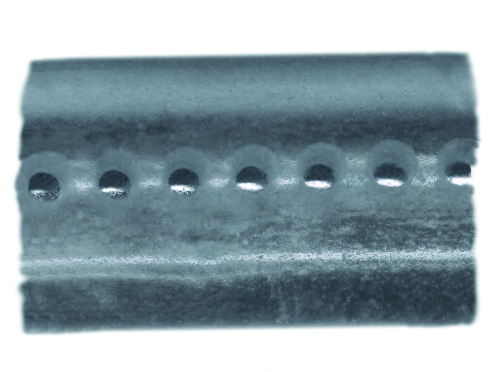 Small 20-micron holes in plastic tubing ablated with a Femto-second laser